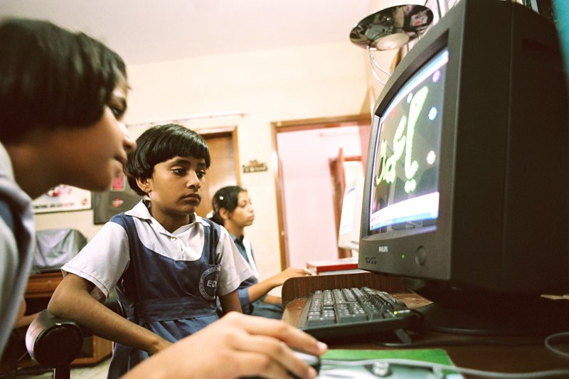 Girls work through a program in a multi&shy;media class at the Clifton home.&nbsp;