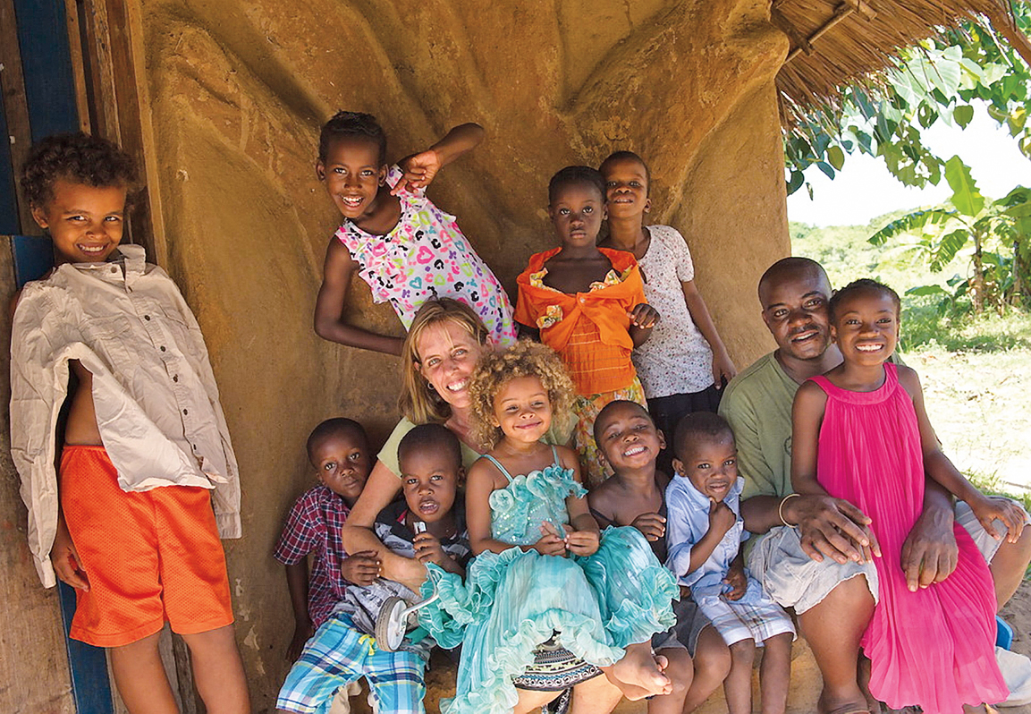 Posing with 10 of the children they care for at The Baobab Home, Terri Place and Caito Mwandu also run health groups for families and children.&nbsp;