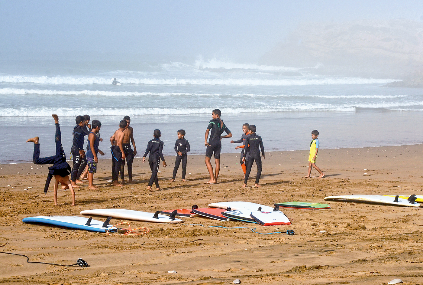 <p>The next generation of Moroccan surfers takes time out from the waves to play on the beach near Devil&rsquo;s Rock.</p>
