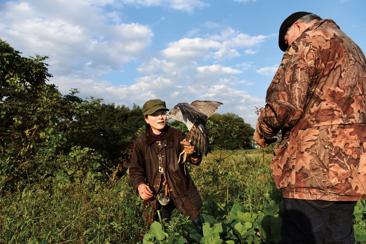 <p>Otsuka emerges from a thicket after retrieving a falcon that had sought refuge upon capturing a pigeon. Training as a falconer, she says, “was not easy,” and she emphasizes the difficulty connecting with the birds. “I didn’t understand what [the falcon] feels, so it took a very long time to fly.”</p>