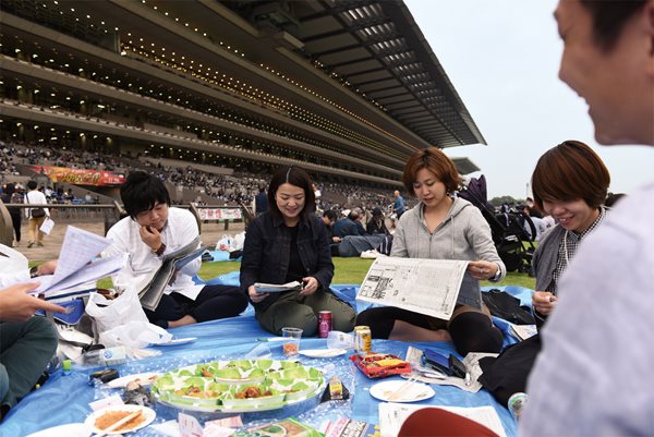 <p>On the grassy center of the track, fans picnic and enjoy cuisine from &ldquo;kitchen-cars&rdquo; parked in the infield. &ldquo;The boys might be here for the horses, but the girls are here for the food!&rdquo; says Shoko Otani, third from right. Tokyo author and racing fan Makoto Yoshikawa observes that at horse races in Japan today, &ldquo;you see so many young people, and there just isn&rsquo;t the difference between income levels, which is great. People enjoy the culture equally.&rdquo;</p>
