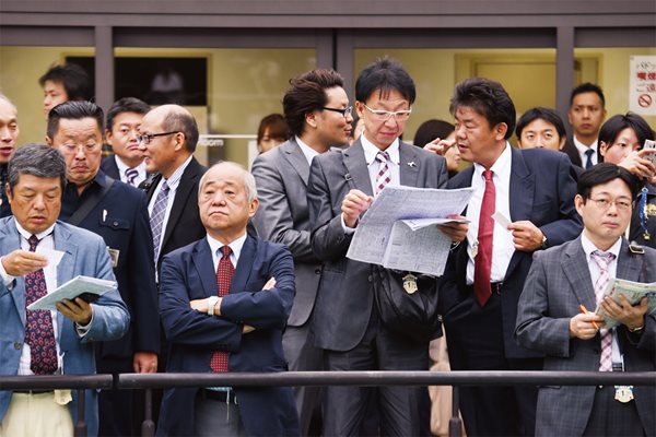 <p>Businessmen and horse owners watch from a private section.</p>
