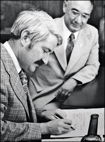 <p><em>Above: </em>At a ceremony in Seattle in 1973, Seattle Mayor Wes Uhlman put his signature on a sister city memorandum after Tashkent Mayor Vahid Kazimov, who looks on. <em>Below:</em> In 1989, the Hotel Uzbekistan in Tashkent welcomed a Seattle delegation in three languages: Uzbek, English and Russian.&nbsp;</p>
