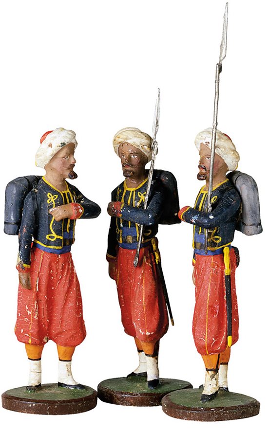 <p>These papier-mâché toy Zouave soldiers sport the red pantaloons, blue jackets with vests and dress turbans that came to characterize the Zouave uniform&mdash;even though colors and designs actually varied widely among Zouave regiments. Eye-catching on parade, such colorful outfits only made Zouaves more visible in the field.</p>
