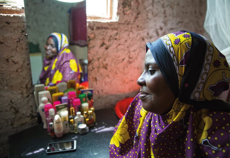 Hidaya poses inside her small home in Bwejuu on Zanzibar&rsquo;s east coast in one of her favorite kanga.