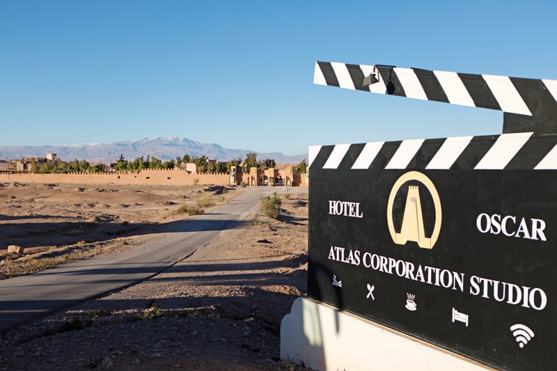 With the 20-hectare production studio in the background, at the edge of the desert beneath the Atlas Mountains, a sign decorated like a film director&rsquo;s clapboard advertises Atlas Studios&rsquo; hotel in Ouarzazate, Morocco.
