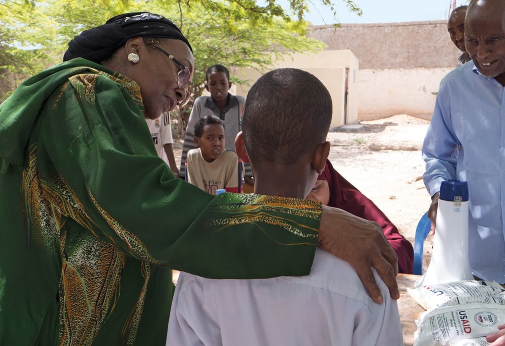 Adan checks that a student is receiving the rations his family needs.