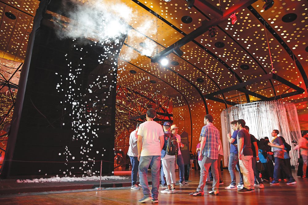 Under the star-like, perforated copper sheeting of the Great Hall, adults and youth view an exhibition titled “Sense and Sensibility” during last year’s annual Tanween festival, which brings global innovators to Ithra.