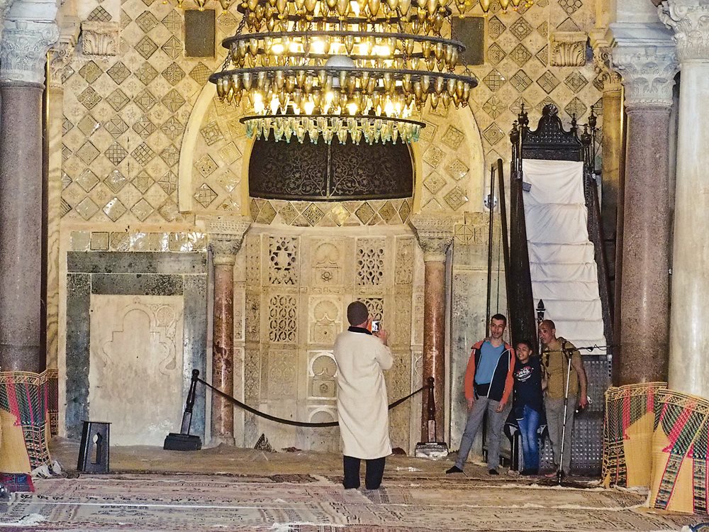 Decorated with shimmering, diagonally set lusterware tiles imported from Iraq in the mosque’s earliest years, the mihrab, or prayer niche.