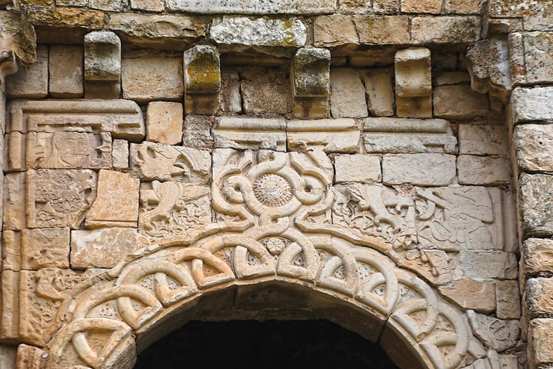 After the Mosul Gate was partly destroyed in the 1970s, its carved features—wolf-headed serpents, the Sun and booted warriors—were mismatched in reconstruction.