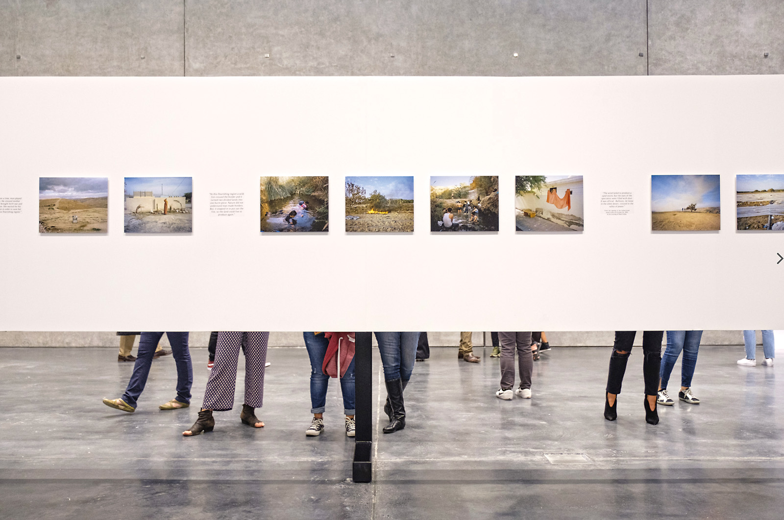 Visitors take in a photo exhibition.