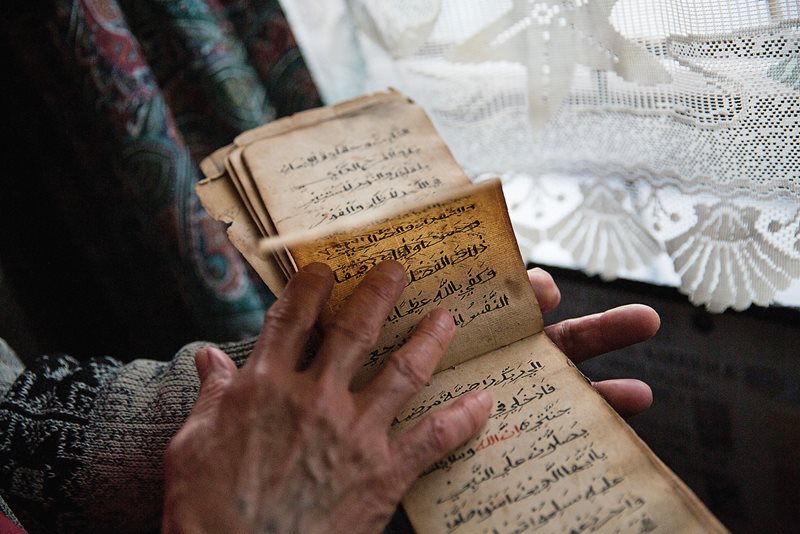 Ebraheim holds one of many kitabs he has collected from self-taught families over the years, which he donates to the Simon&#39;s Town Heritage Museum.