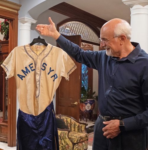 Richard holds a uniform from the Syrian Lebanese league’s San Antonio team whose letters “ame syr” stand for “American Syrians.”