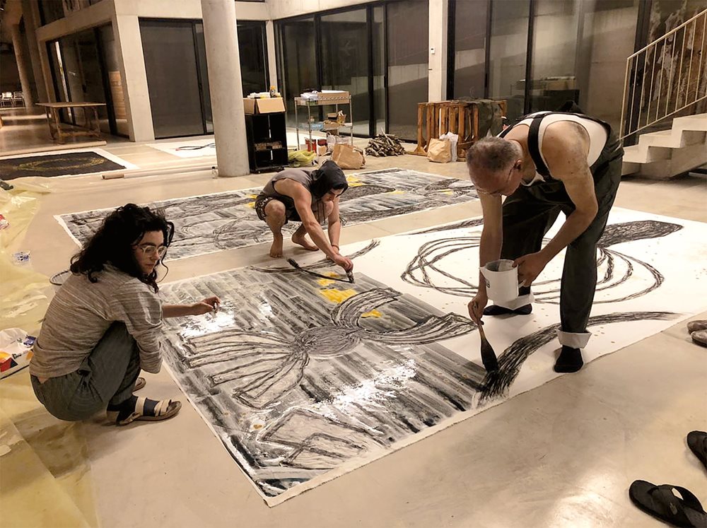 Nadim Karam, right, paints with members of his family.