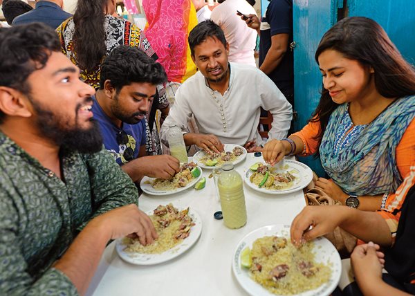 Rolling rice and meat with the right hand is the traditional way to dine on biryani at the Original Haji Biryani in Dhaka, Bangladesh.