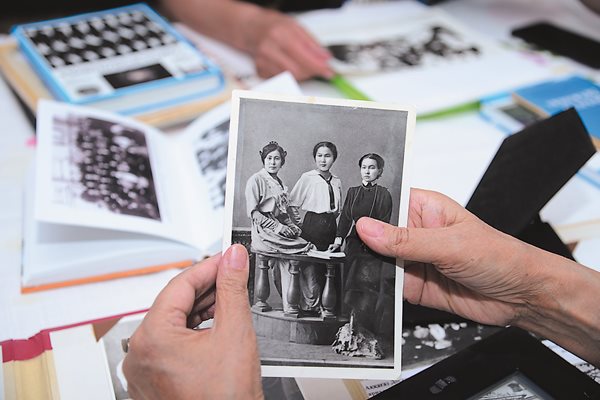 In her home in Almaty, Kazakhstan, Doszhanova’s granddaughter Aizhan Yershina proudly maintains a shelf of family photos that includes a portrait of her grandmother as a young woman taken from a 1913 photo, lower, that shows Doszhanova flanked by classmates at the time of her graduation from secondary school at the Women’s Gymnasium of Orenburg.