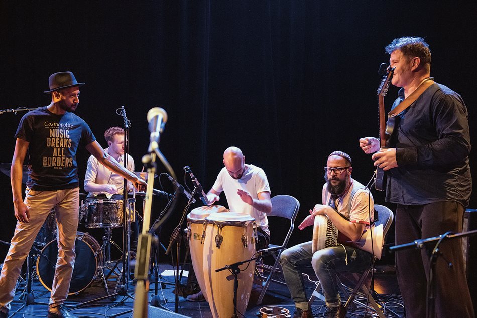 “Music Breaks All Borders,” reads Zouiten’s T-shirt as he holds a microphone to accompanying percussionists riffing off one another during a Berlin performance. Zouiten, 37, has also trained on piano, violin and classical guitar, and he is currently studying ethnomusicology at the Hochschule für Musik FRANZ LISZT Weimar in his pursuit to “continually propose new musical perspectives.”