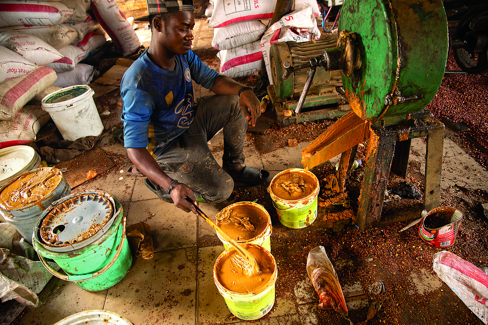 One of Ceesay’s employees paddles peanut butter into tubs from one of the small paste-making machines YEP helped Ceesay purchase. From seed to product, the groundnut economy accounts for some 80 percent of Gambia’s agricultural sector, and is one of the country’s leading exports, according to the UN’s Food and Agriculture Organization of the United Nations.