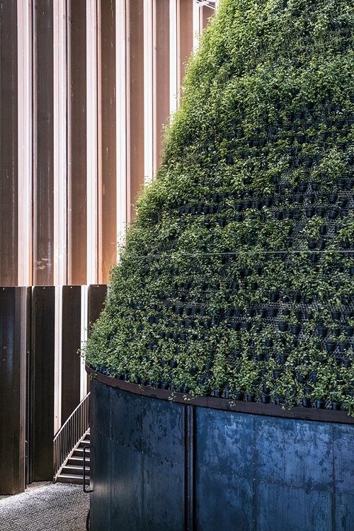 Colored lights enhance the presentation of full-circle water sustainability in the pavilion of The Netherlands, where a self-contained system also irrigated a green cone, right, that grew a variety of plants including tomatoes. 