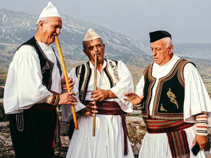 Shkelqim Beshiraj, far right, gives instruction to his group, whose members have spent the past four years rehearsing for the festival. Beshiraj, who is in his 70s, has racked up 1.5 million views on his official YouTube page. 