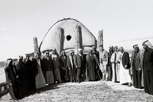 For this group photo, taken at the request of one of my many hosts over my time among the Ma'dan, we stood in front in of . mudhif.