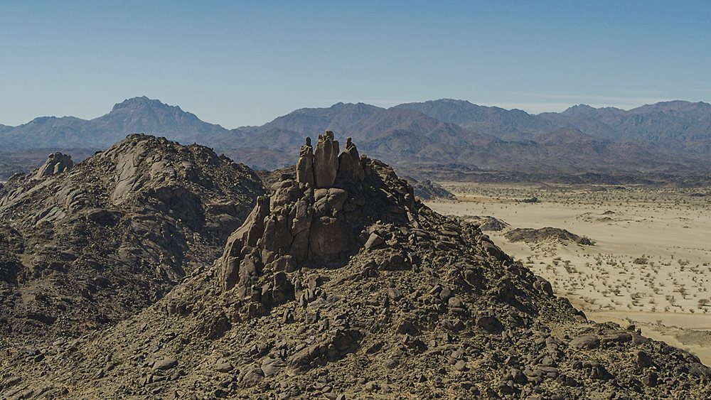 Rising like a cluster of watchmen, an outcropping of stones marks a hilltop along the route of the Hijrah.