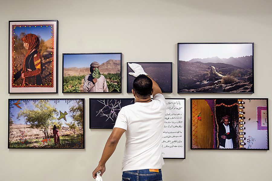 A Drik curator makes final adjustments to the display of the World Press Photo award-winning visual story from Rehab Eldailil, a documentary photographer living in Cairo, Egypt. “The Longing of the Stranger Whose Path Has Been Broken” focused on the broad theme of identity, which she and her subjects explored through participatory creative practices that included not only photography but also multimedia, writing and embroidery.