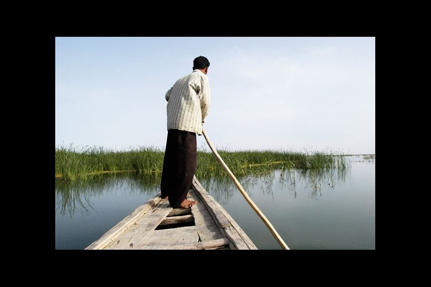 The region known as Abu Zirig, left, is one of the marshland regions re-inundated last year, bringing the total area flooded to about 40 percent of the original expanse. Alwash and staff members of the year-old Center for the Restoration of Iraqi Marshes (CRIM) make regular journeys in the slim, poled boats of the Ma'dan people to record water levels, salinity, pH and temperature, and to count birds and fish. 