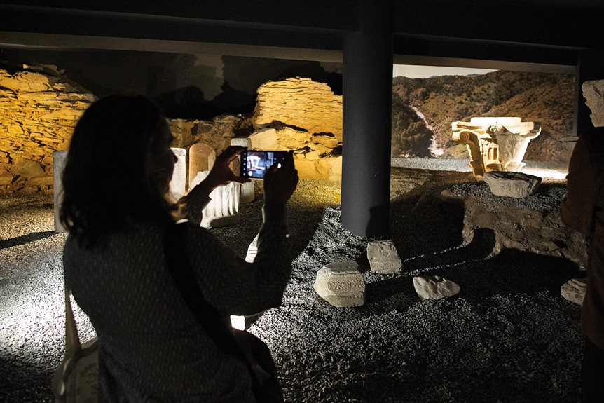 A Spanish student takes a picture of artifacts from a Roman house that is showcased under the municipal building in Mértola. Tourism has steadily increased, benefiting the local economy.