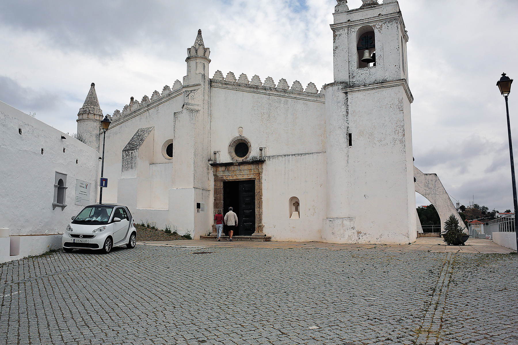 Visitors tour the Church of Nossa Senhora da Anunciação. The church, which was previously a mosque, has its altar turned toward Makkah.