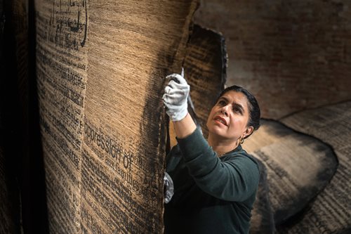 Manal AlDowayan works on her art piece “Shifting Sands: A Battle Song.”