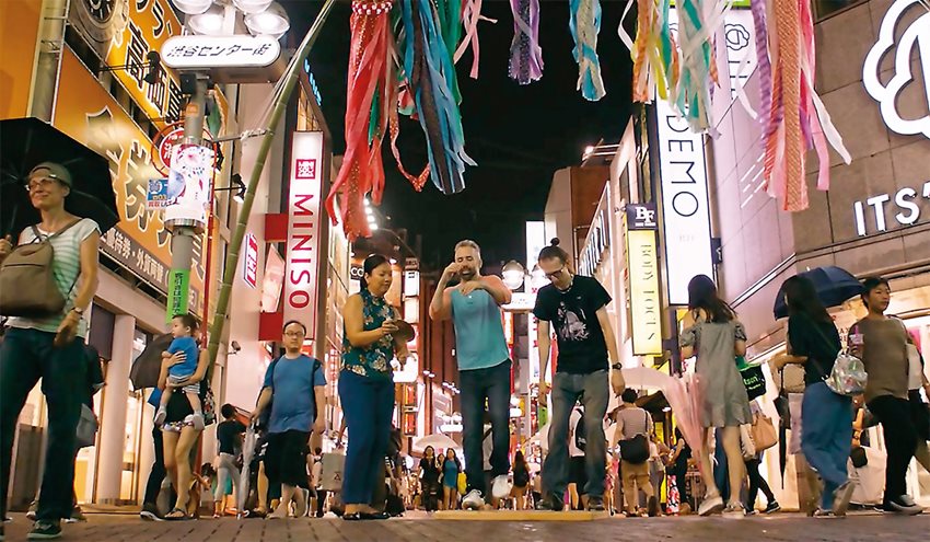 A screen shot from the film Identity: The Andrew Nemr Story shows Nemr performing on the streets of Tokyo. The documentary film unpacks the complexities of Nemr’s life-journey with tap dancing.